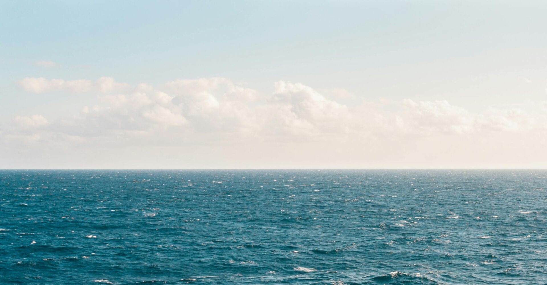 Tranquil ocean view under a clear sky, capturing the serene beauty of the expansive water.