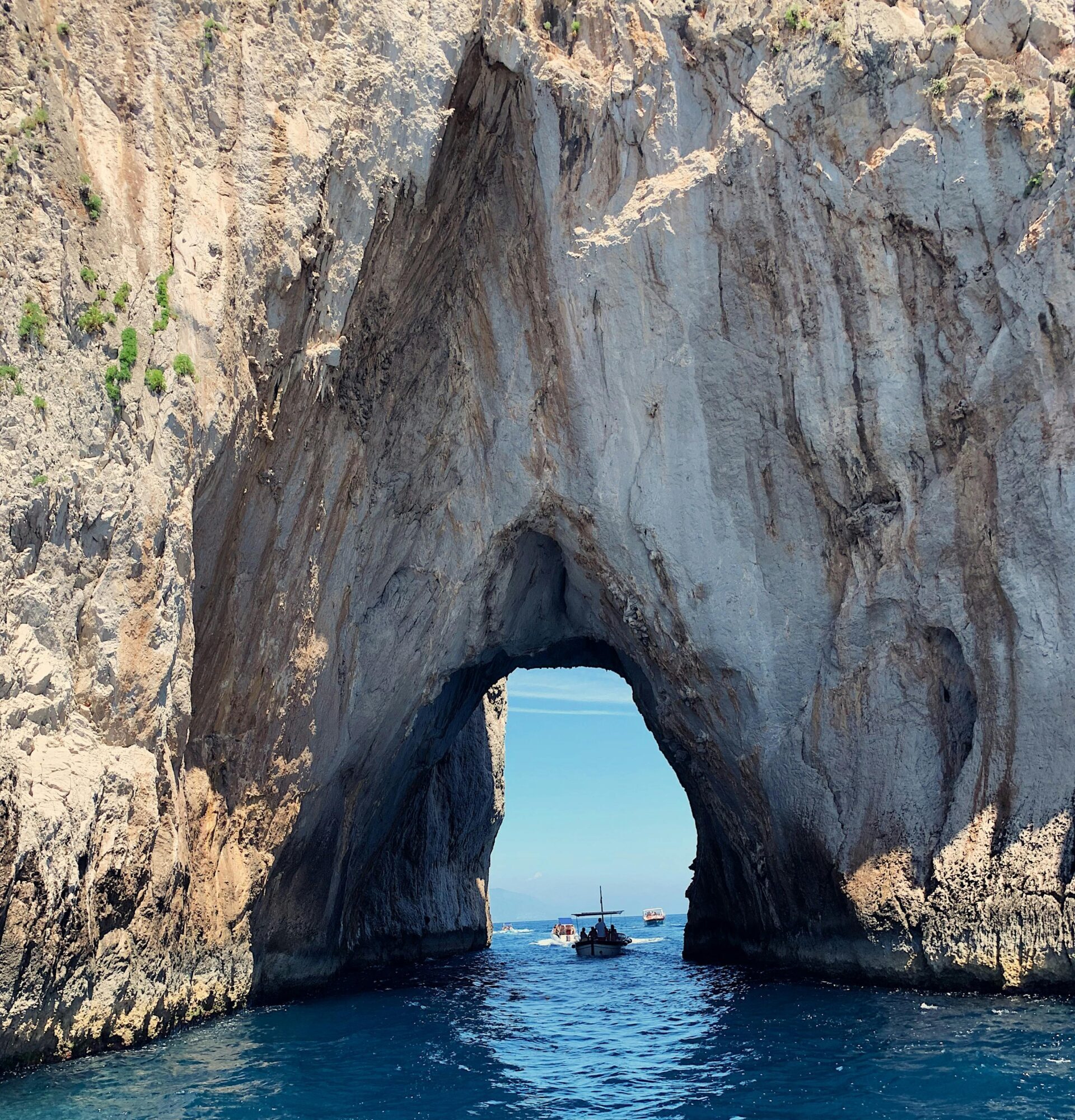 Stunning rock archway over blue waters at Capri, Italy, capturing natural beauty.