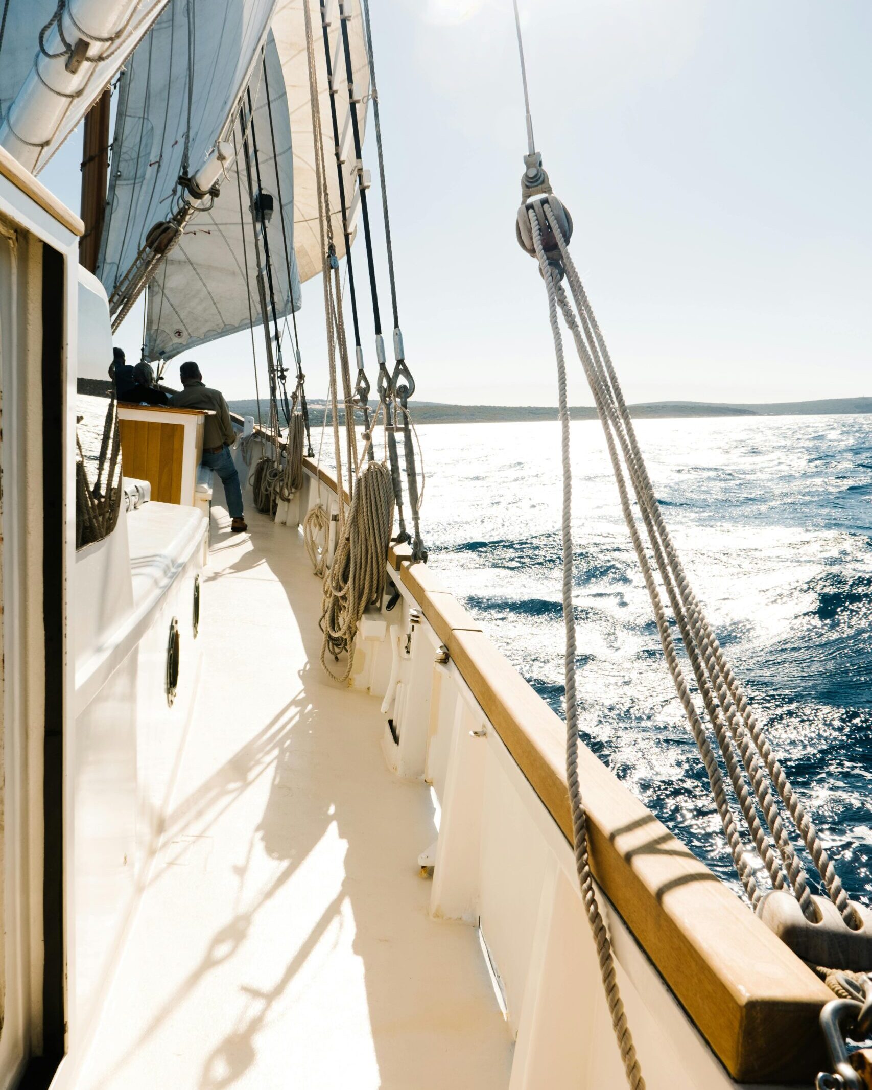 Experience the thrill of sailing across sunlit waters with a classic sailboat.